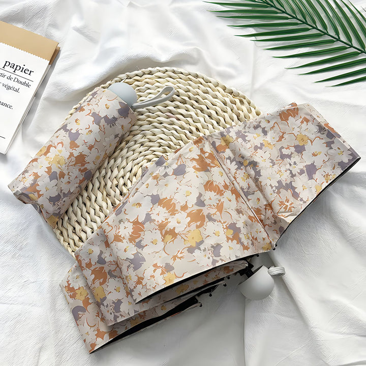 Damer Sammenleggbart paraply med elegant blomsterdesign Skanto