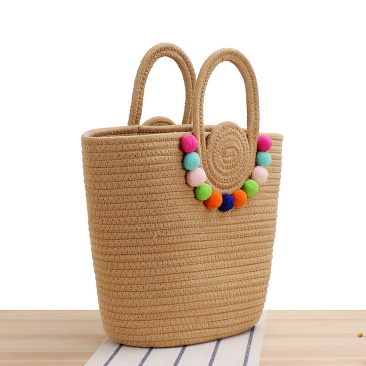 Modern handbag with playful pom-pom embellishments Skanto