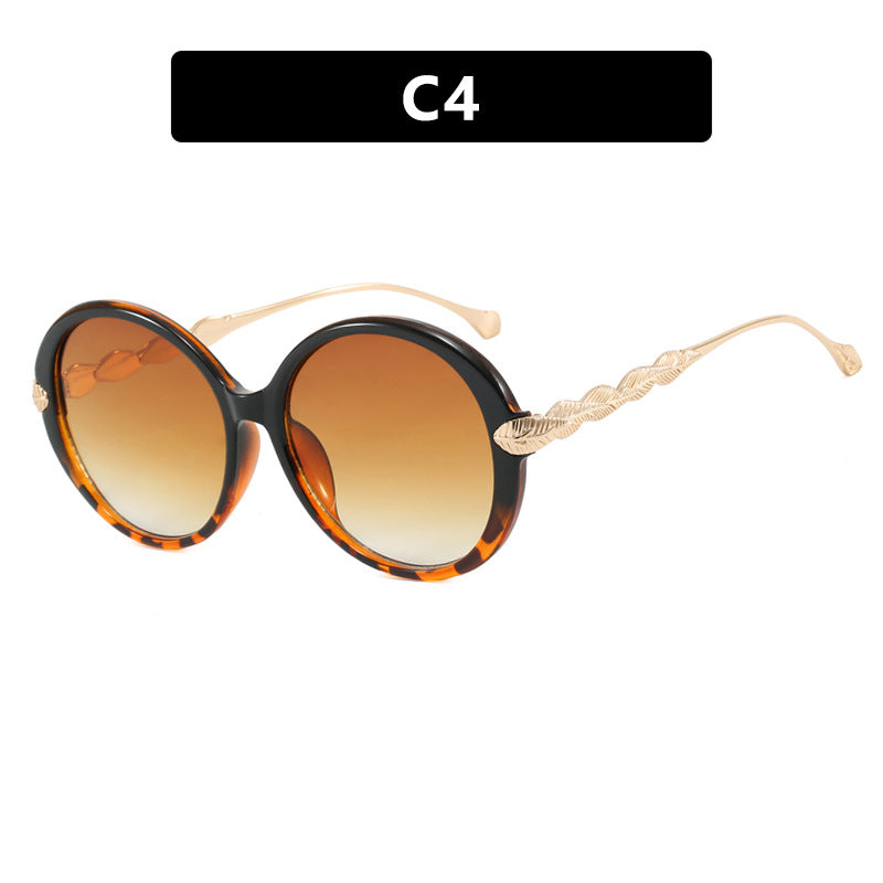 Dame stor rund solbrille med dekorative metalakser Skanto