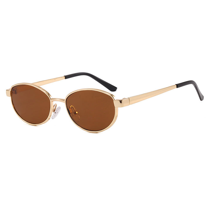 Dame moteriktig solbrille i elegant oval design med ramme i høykvalitets metall Skanto