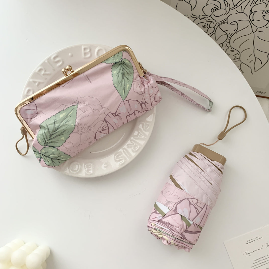 Damer elegant foldeparaply med blomsterdesign og praktisk etui Skanto