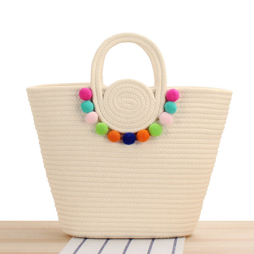 Modern handbag with playful pom-pom embellishments Skanto