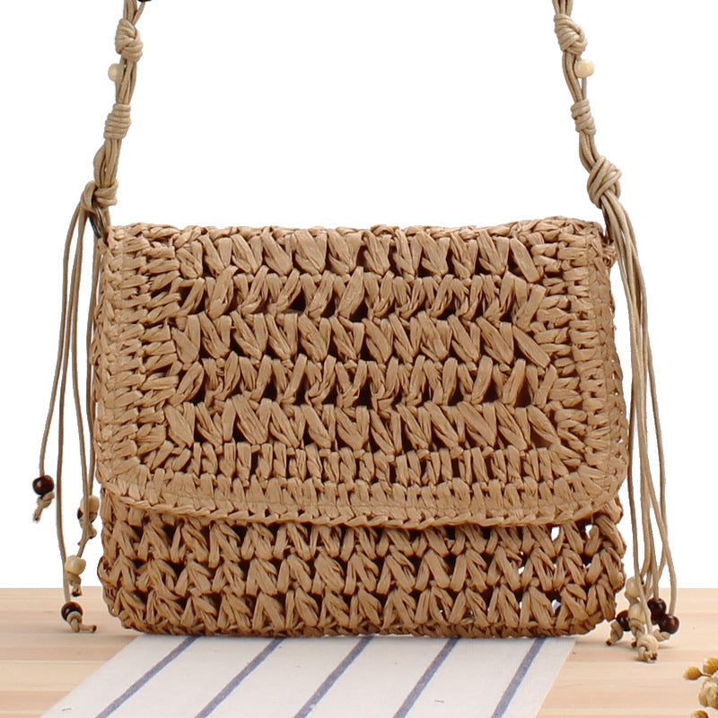 Woven natural material handbag with playful fringes Skanto