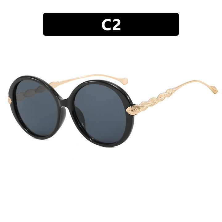 Dame stor rund solbrille med dekorative metalakser Skanto