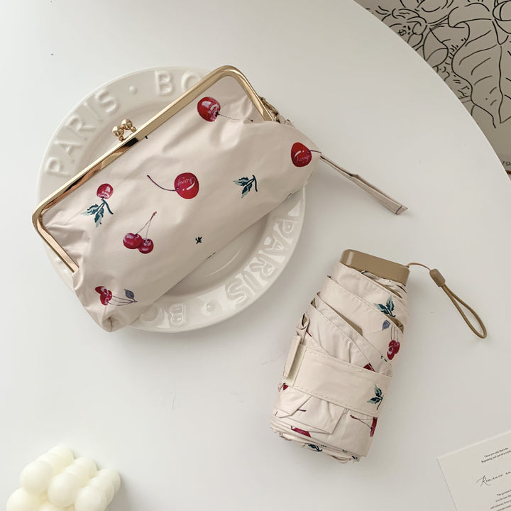 Damer elegant foldeparaply med blomsterdesign og praktisk etui Skanto