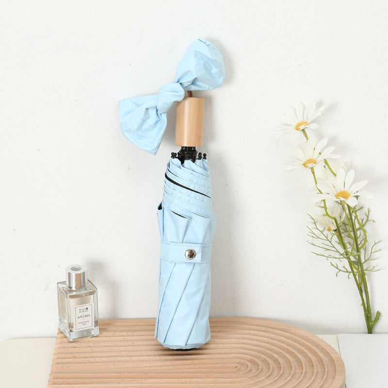 Dame kompakt sammenleggbart regnparaply med elegant design og ergonomisk tremanor Skanto