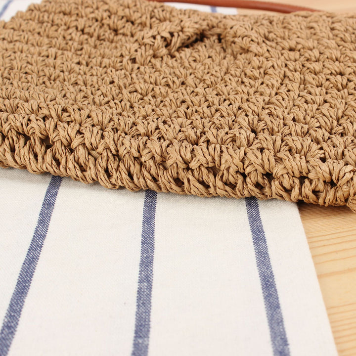 Handbag made of braided natural material with elegant button closure Skanto