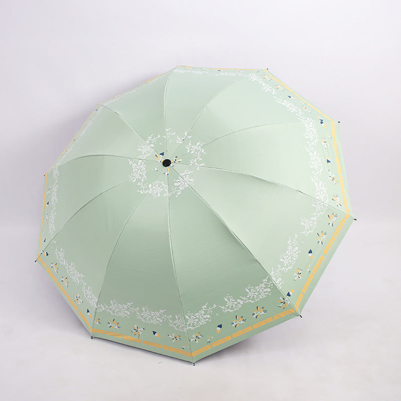 Kvinnens elegante sammenleggbare paraply med blomsterdesign Skanto