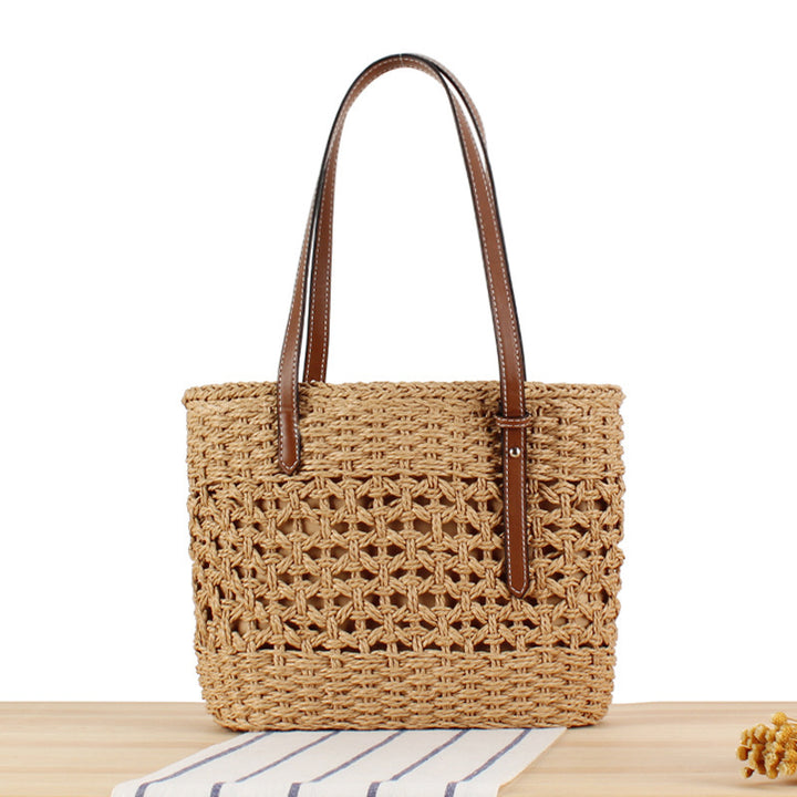 Handbag made of hand-woven straw with elegant faux leather handles Skanto