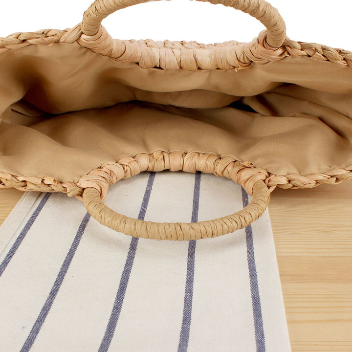 Woven natural material handbag with elegant round handle Skanto