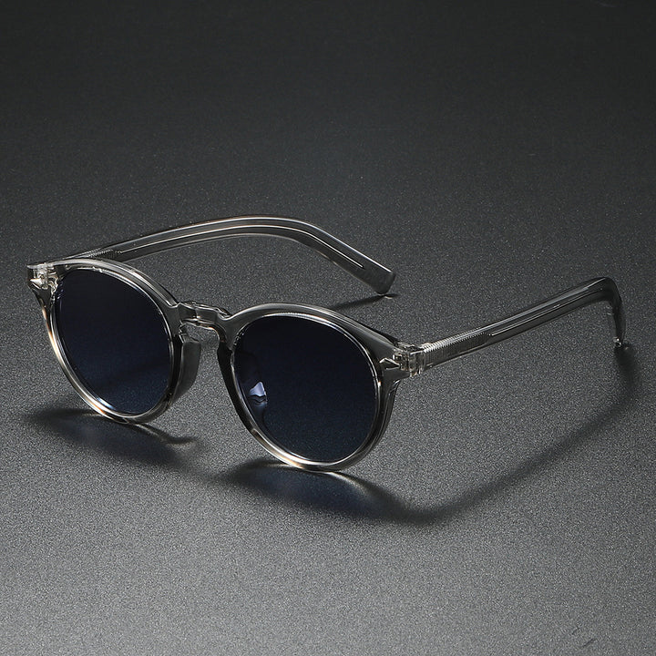 Dame Rund-solbrille med transparent ramme og reflekterende glass Skanto