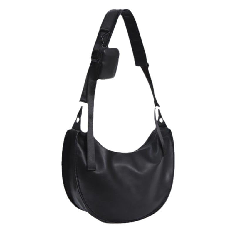 Elegant skulderveske i buet form Skanto