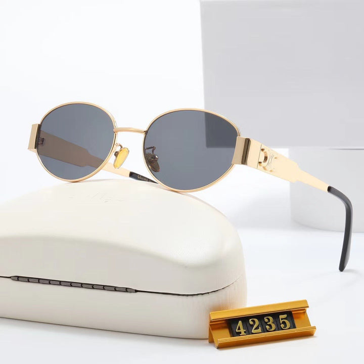 Dame elegant oval solbrille med gullfarget ramme Skanto