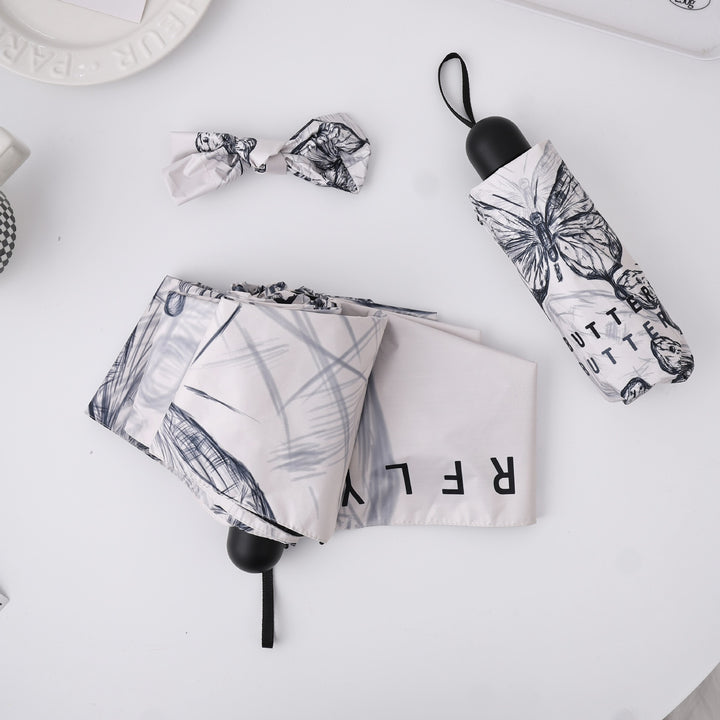 Dame fashionable foldeparaply med leken design Skanto