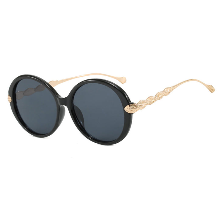 Dame stor rund solbrille med dekorative metalakser Skanto