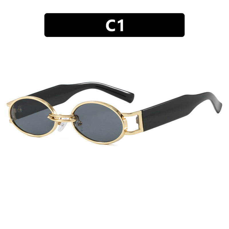 Dame ovalformet solbrille med gullige accenter og stilig ramme Skanto