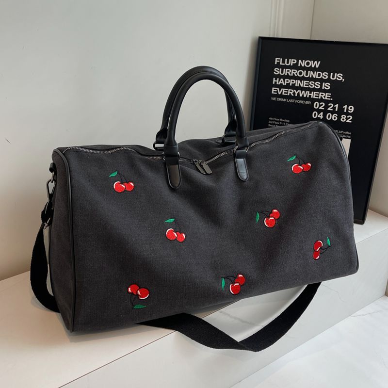 Sporty weekend bag with playful cherry pattern Skanto