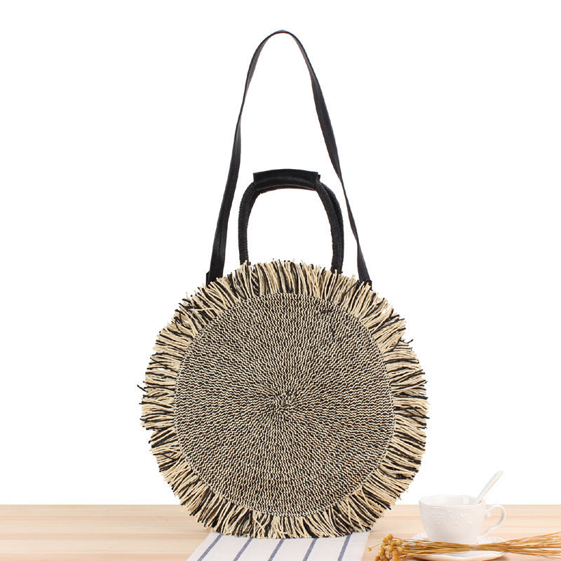 Round bag with fringe detail Made of braided material Skanto