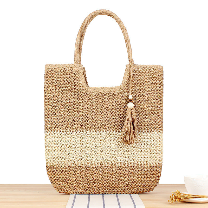 Modern beach tote bag made of woven natural material with fringed details Skanto