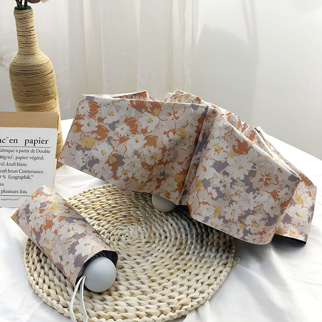 Damer Sammenleggbart paraply med elegant blomsterdesign Skanto