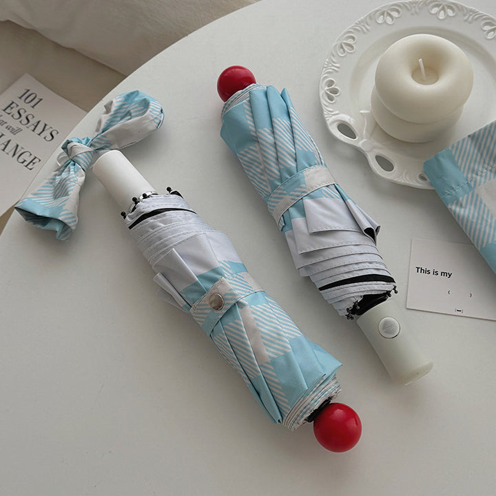 Dame sammenleggbart paraply med spesiell design Skanto