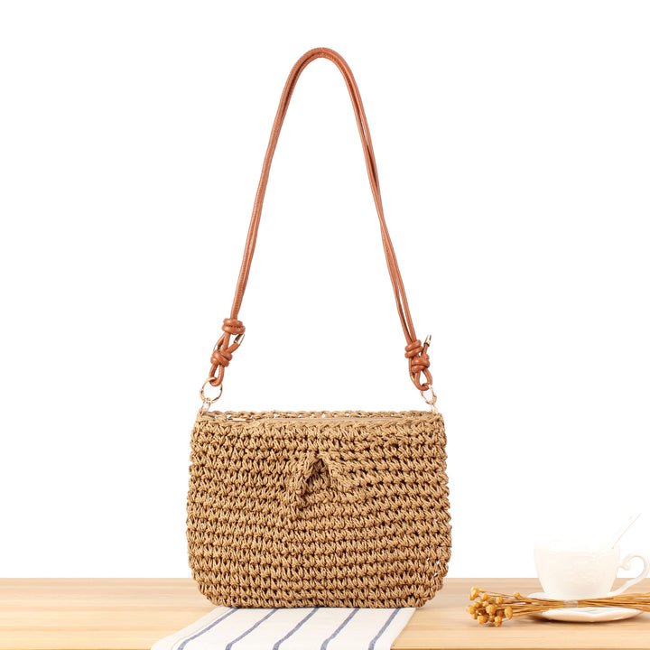Handbag made of braided natural material with elegant button closure Skanto