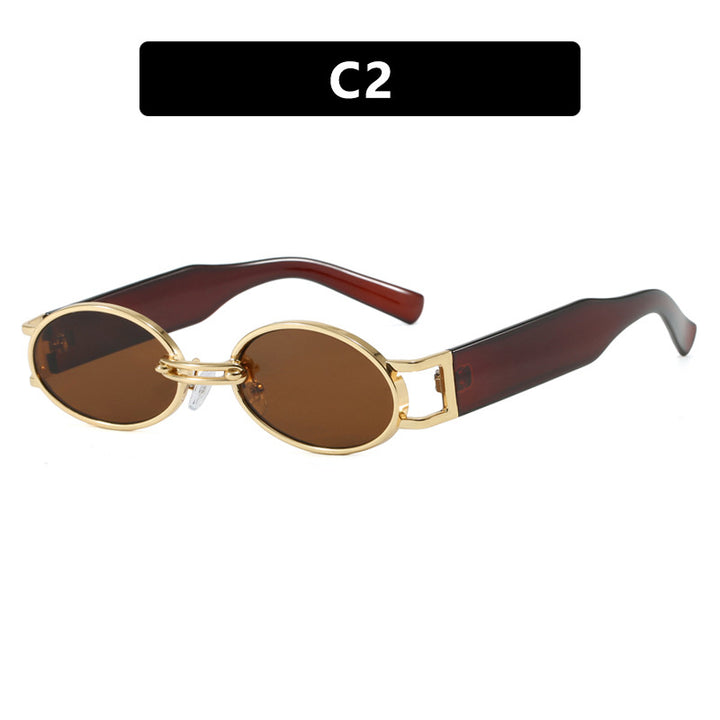Dame ovalformet solbrille med gullige accenter og stilig ramme Skanto