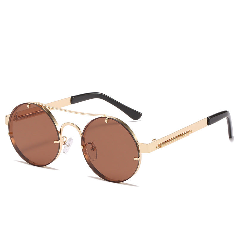 Dame rund designer solbrille med innovativ metallramme og beskyttende linser Skanto