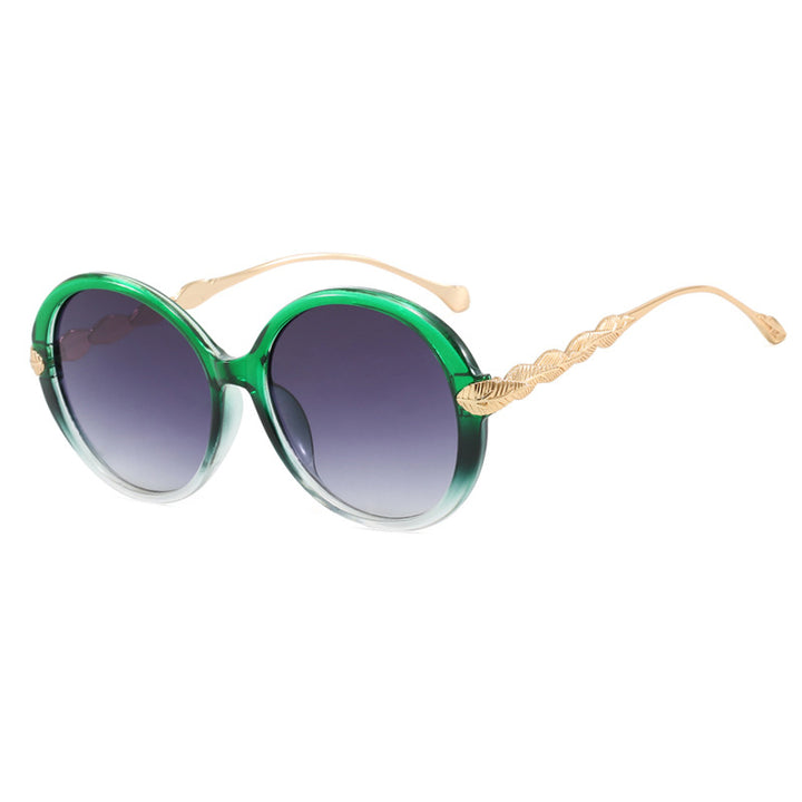 Dame stor rund solbrille med dekorative metalakser Skanto