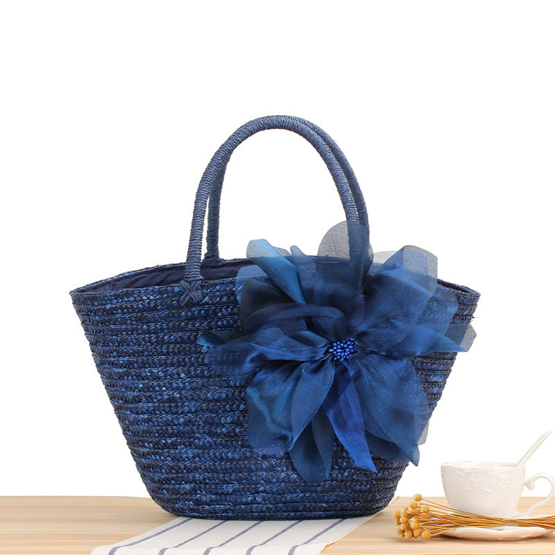 Elegant straw bag with floral accents Skanto