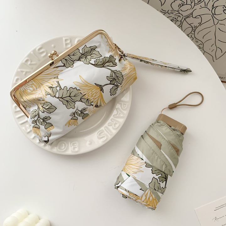 Damer elegant foldeparaply med blomsterdesign og praktisk etui Skanto