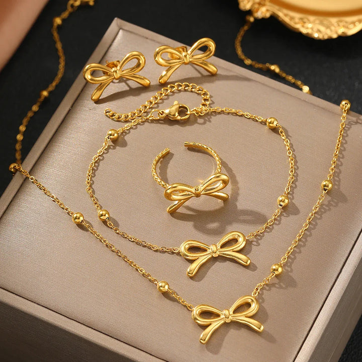 Skanto | Feminine Bow Satellite Chain Necklace, Bracelet, Earrings, and Ring Set