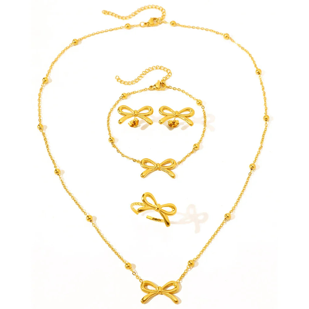 Skanto | Feminine Bow Satellite Chain Necklace, Bracelet, Earrings, and Ring Set
