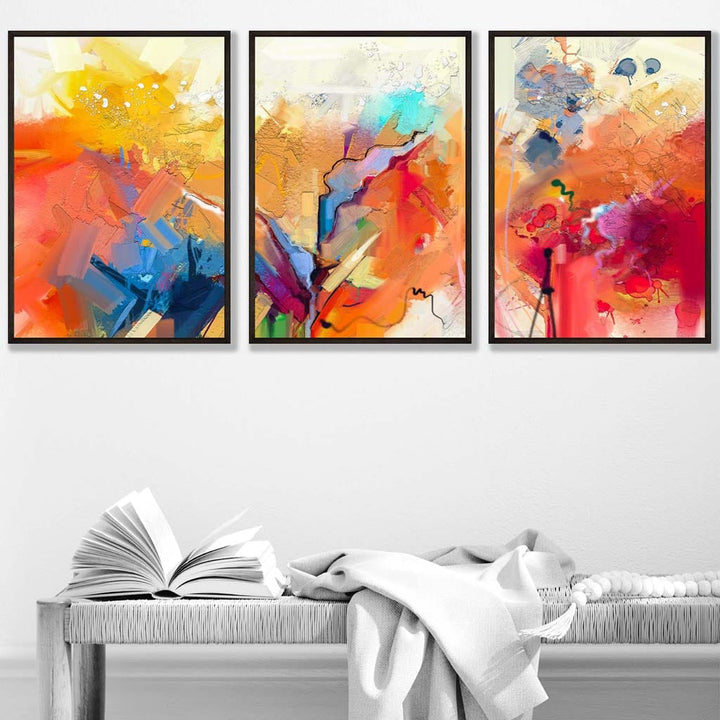 Abstrakt, fargerikt sett med tre veggkunstverk i oransje, rosa og rødt.