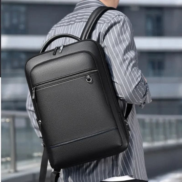 Skanto | Elegant lær ryggsekk for menn/kvinner med USB-port for laptop og hverdagsbruk, 15,6 tommer, svart